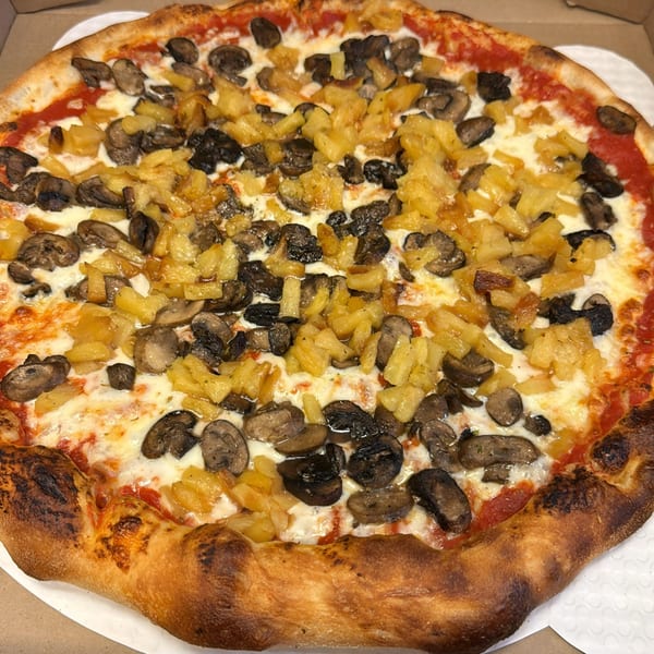 Biaggio Pizzeria's whole pizza with mushrooms and pineapple, in a white pizza box.