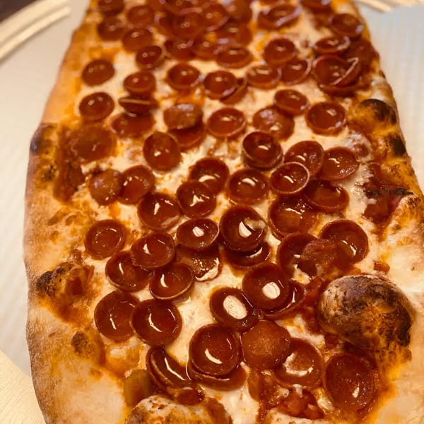 Close-up of a rectangular pepperoni pizza from Biaggio Pizzeria, with crispy crust and melted cheese.